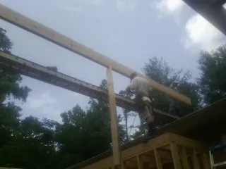 Carpenter setting a ridge beam over a new addition frame — Ice Dam Removal by Roofing Brothers in Sparks Glencoe